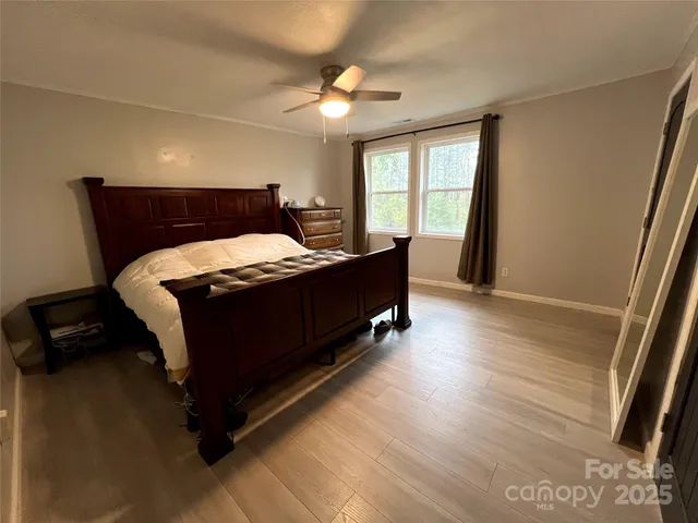 a bed sitting in a bedroom next to a window