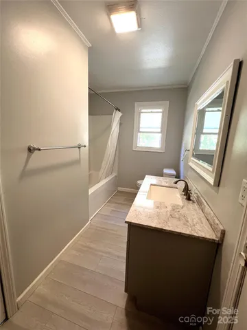 a en suite bathroom with a sink shower and a mirror