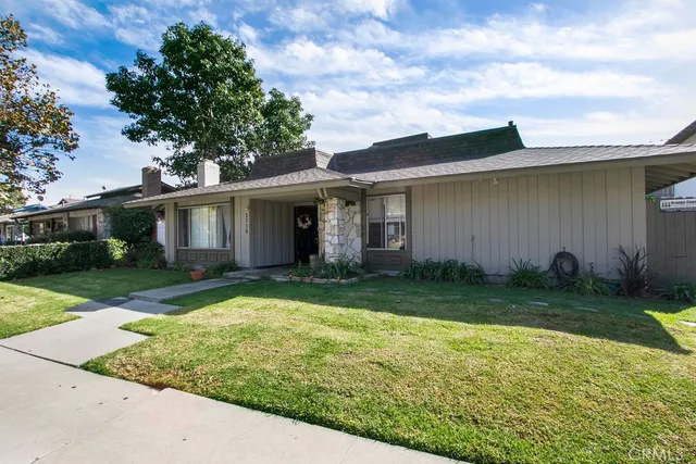 a view of a house with garden and yard