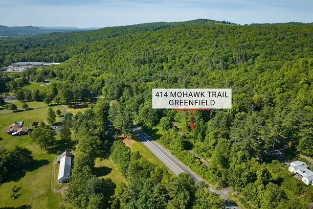 a sign that is sitting on a lush green field