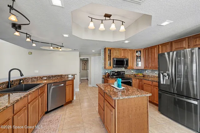 a bedroom with a bed and flat tv screen on the dresser