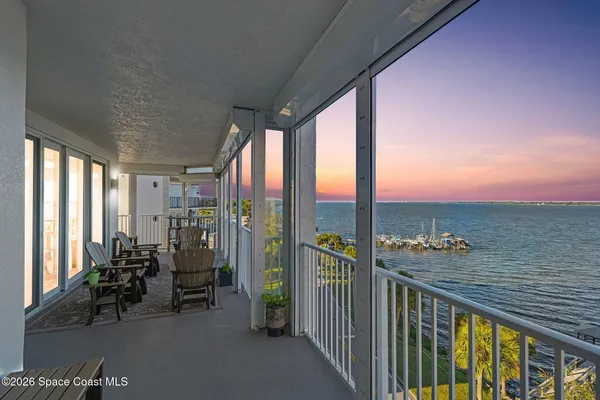 a bedroom with a bed and a flat tv screen on dresser