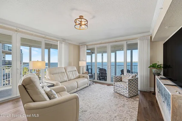 a bedroom with a bed and flat tv screen on the dresser