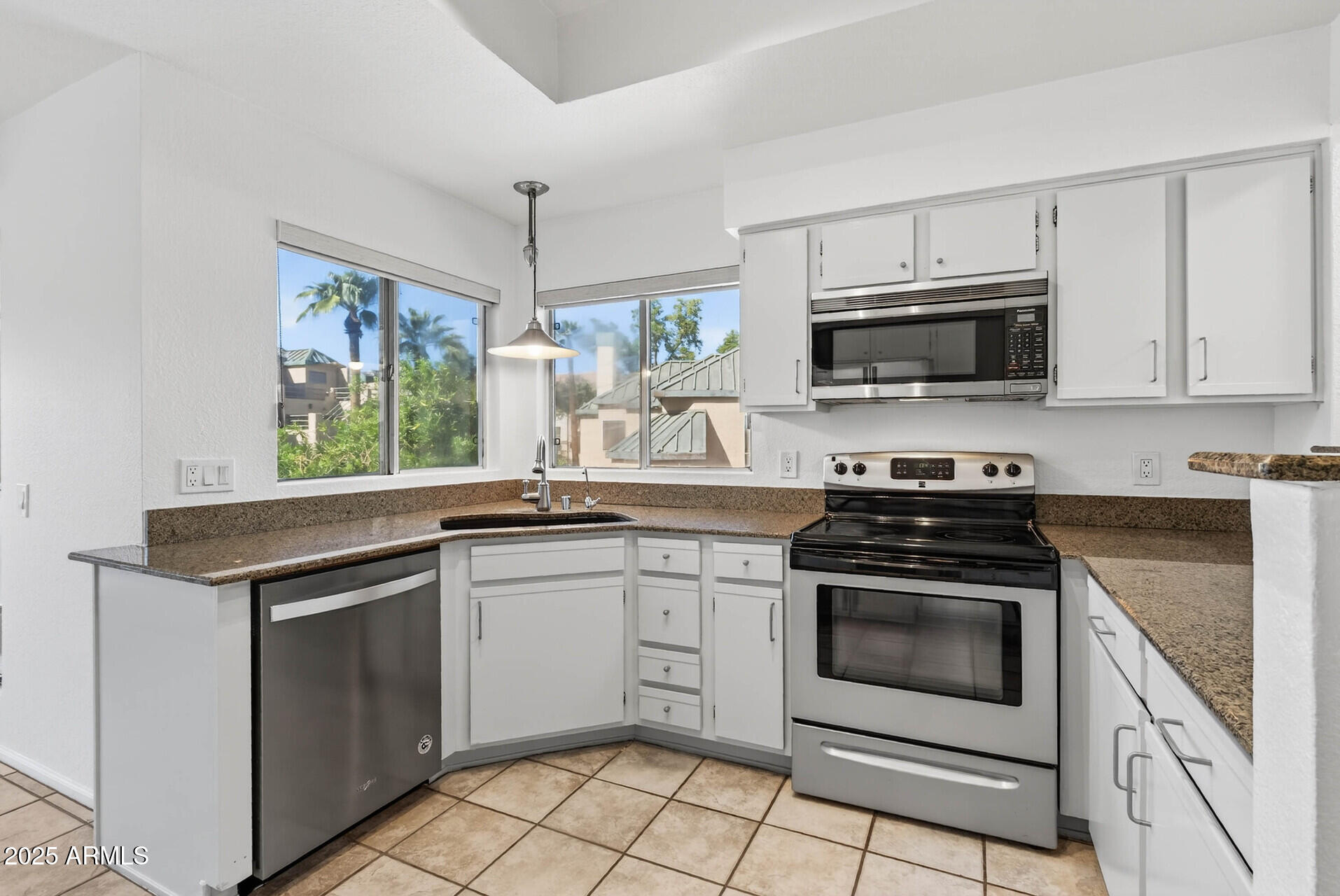 101 North 7th Street, Unit 245 Phoenix, AZ 85034 - Photo 11 of 37 a kitchen with cabinets stainless steel appliances and wooden cabinets