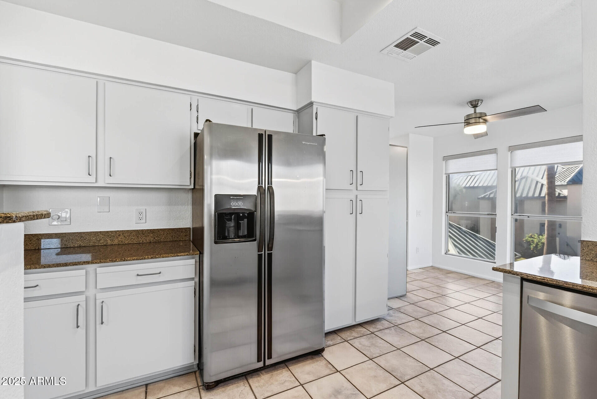 101 North 7th Street, Unit 245 Phoenix, AZ 85034 - Photo 13 of 37 a kitchen with stainless steel appliances granite countertop a refrigerator a sink and white cabinets