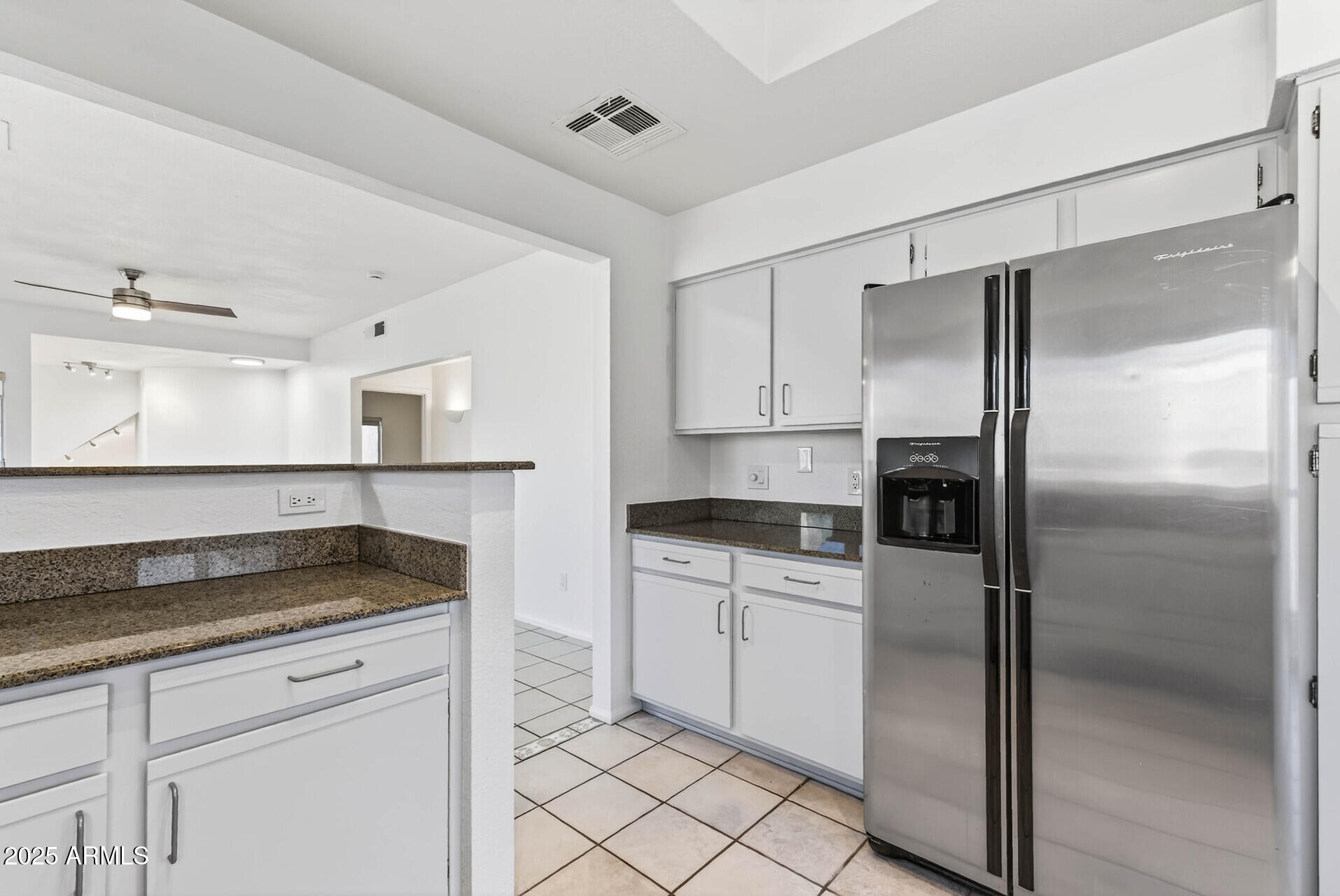 101 North 7th Street, Unit 245 Phoenix, AZ 85034 - Photo 14 of 37 a kitchen with granite countertop white cabinets and stainless steel appliances