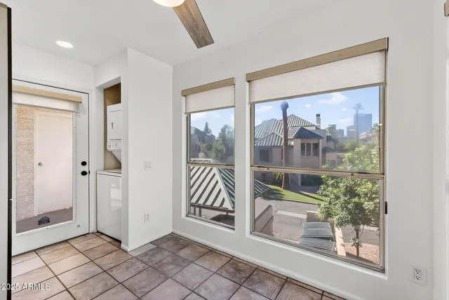 a view of a refrigerator in kitchen and white cabinets
