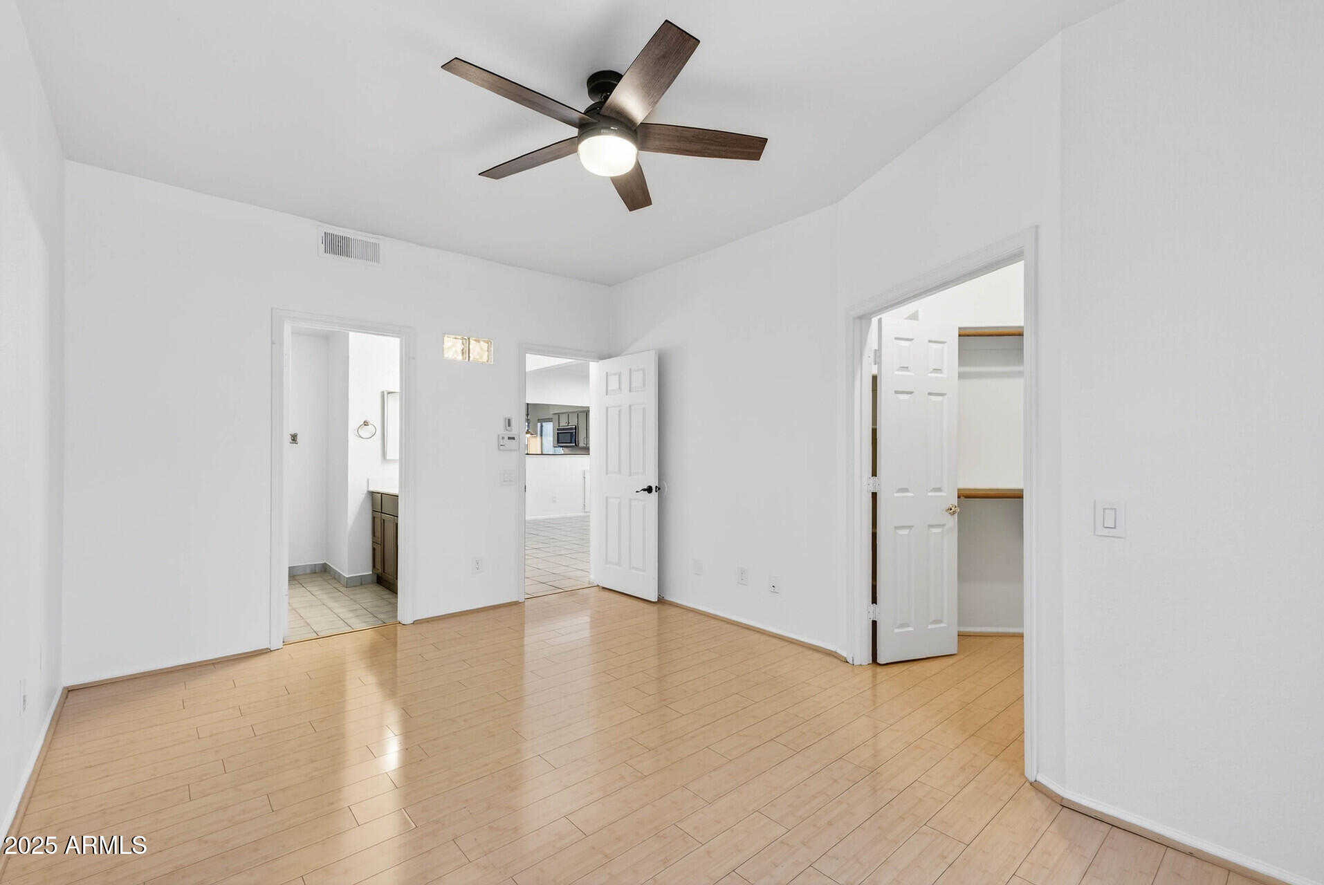 101 North 7th Street, Unit 245 Phoenix, AZ 85034 - Photo 22 of 37 a view of a big room with wooden floor and a ceiling fan