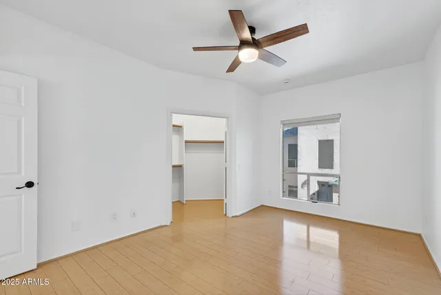 a view of walk in closet with empty racks