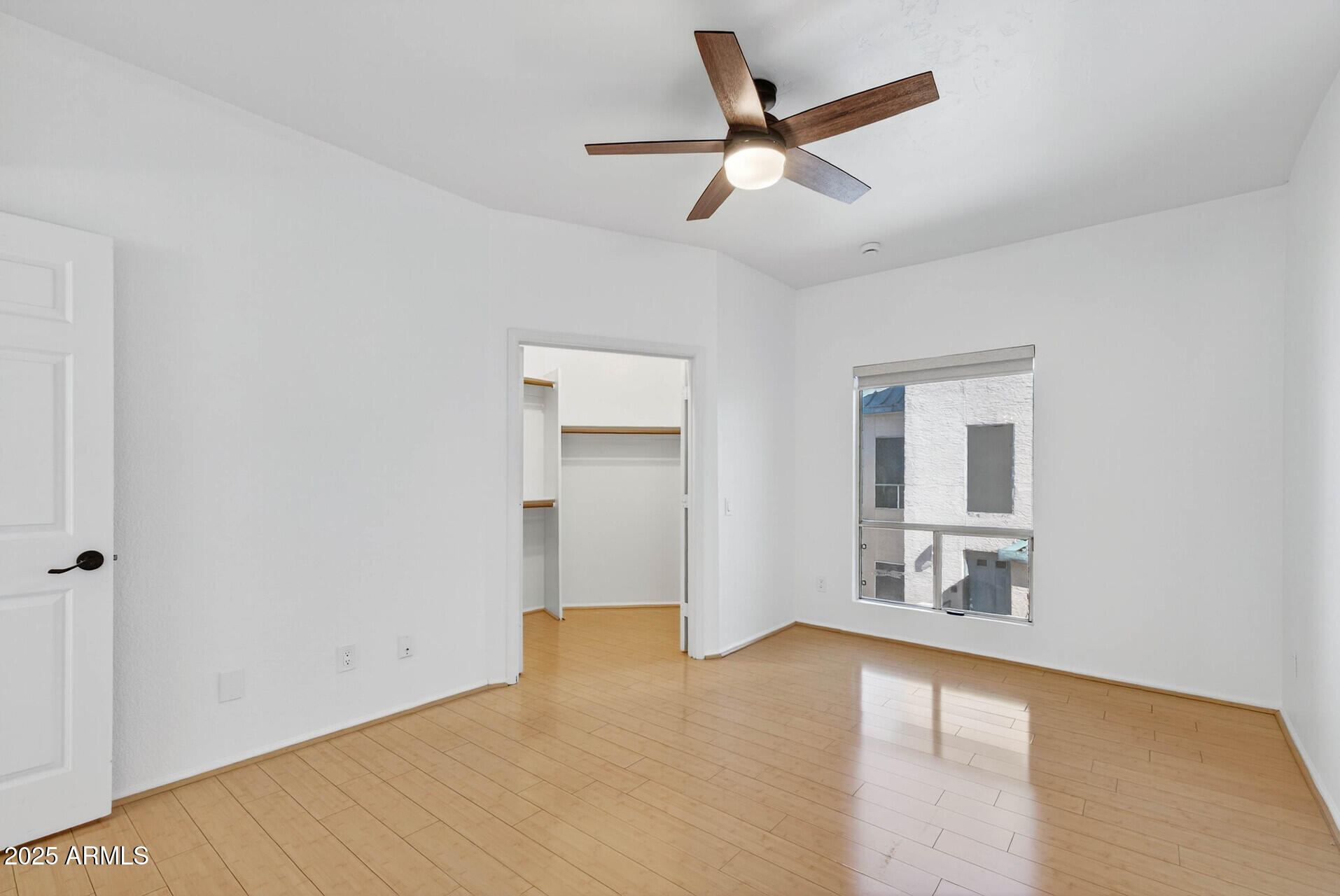 101 North 7th Street, Unit 245 Phoenix, AZ 85034 - Photo 23 of 37 an empty room with wooden floor and windows