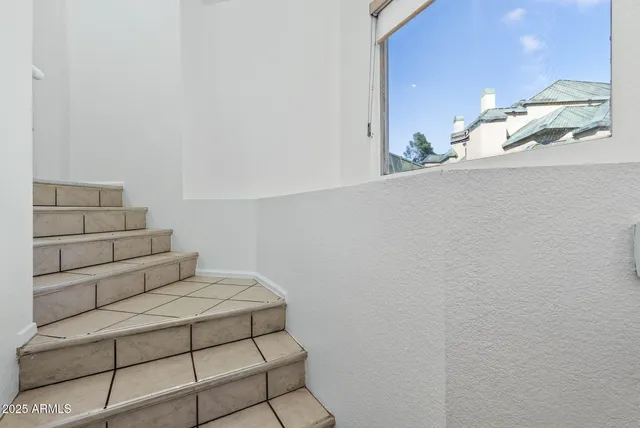 a view of a hallway with bathroom and shower