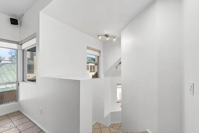 a view of an empty room with a fireplace and a window
