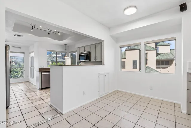 a kitchen with cabinets stainless steel appliances and wooden cabinets