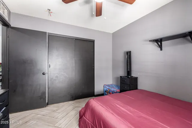 a bedroom with a bed and a chandelier