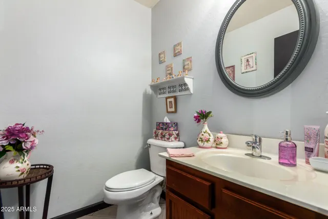 a bathroom with a toilet a sink and a mirror