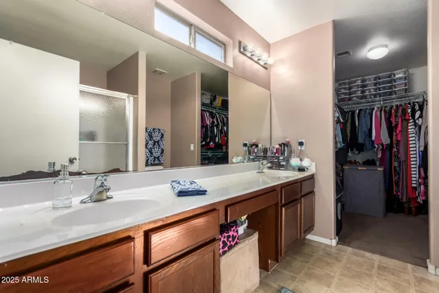a bathroom with a sink double vanity and a mirror