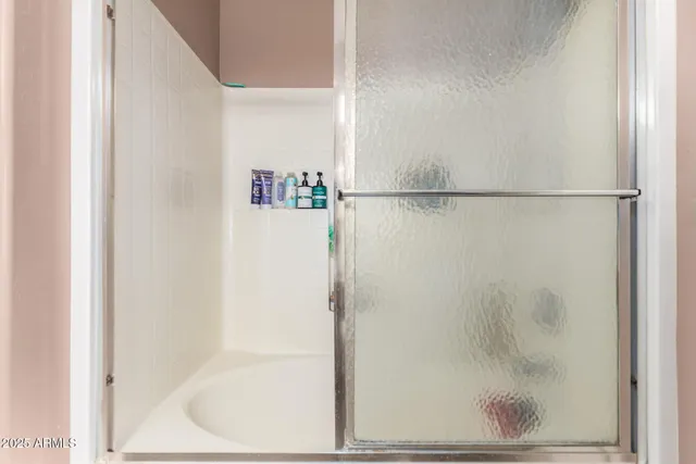 a bathroom with a glass shower door