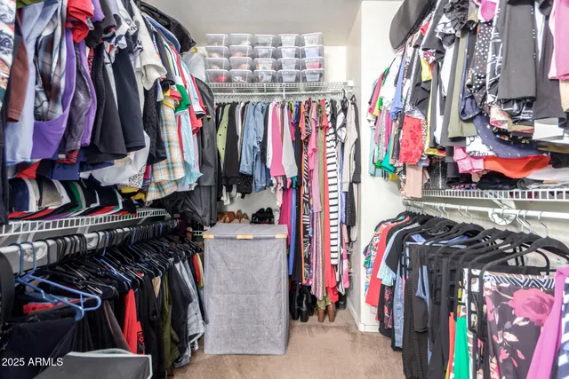 a view of walk in closet with clothes