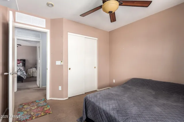 a bedroom with a bed and cabinets