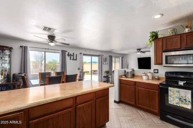 a large kitchen with kitchen island granite countertop a sink and stainless steel appliances