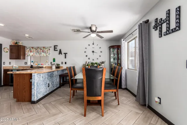 a dining room with furniture a chandelier and wooden floor