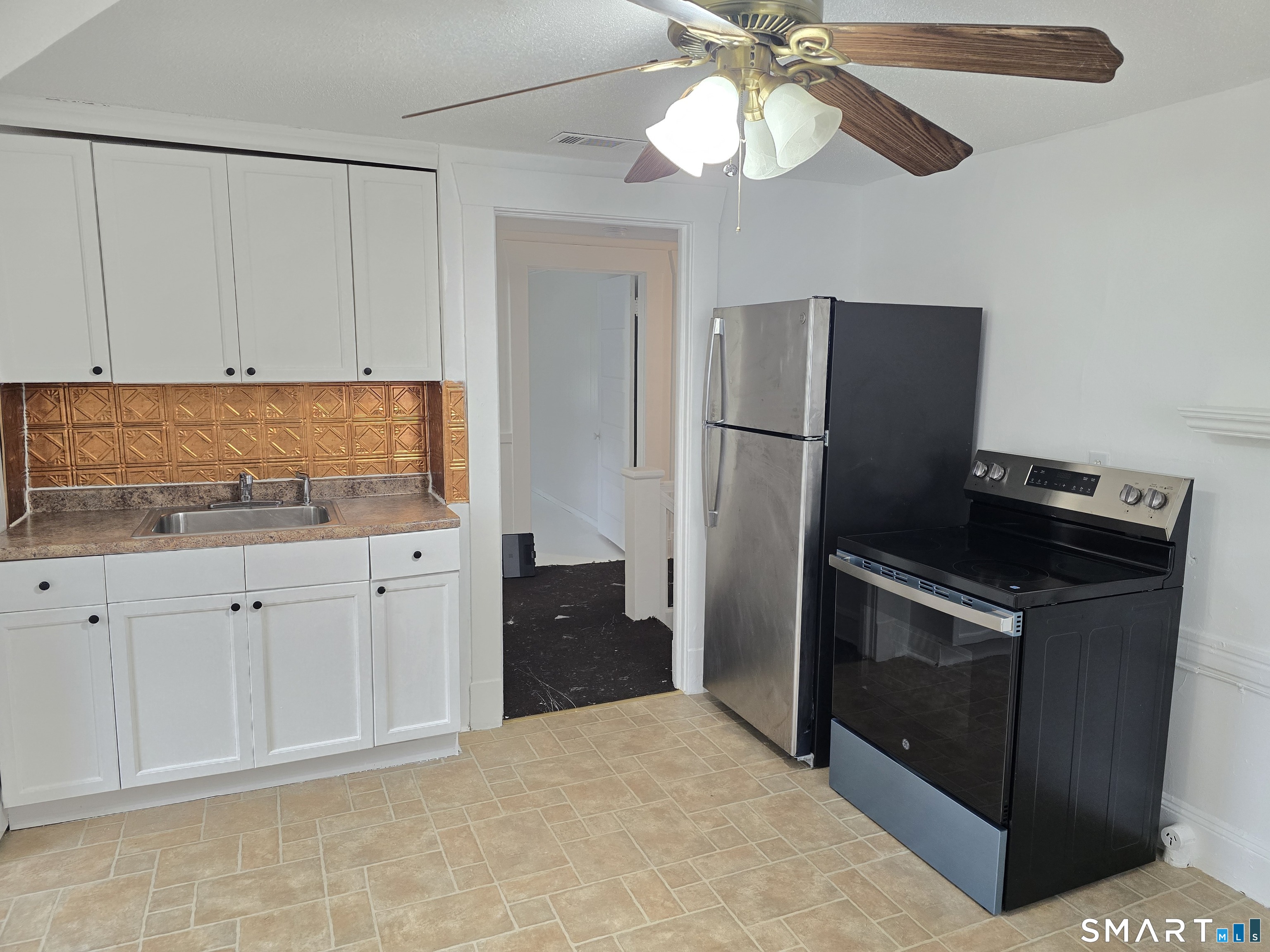 103 Capen Street, Unit 2 Windsor, CT 06095 - Photo 1 of 10 a kitchen with a stove refrigerator and cabinets