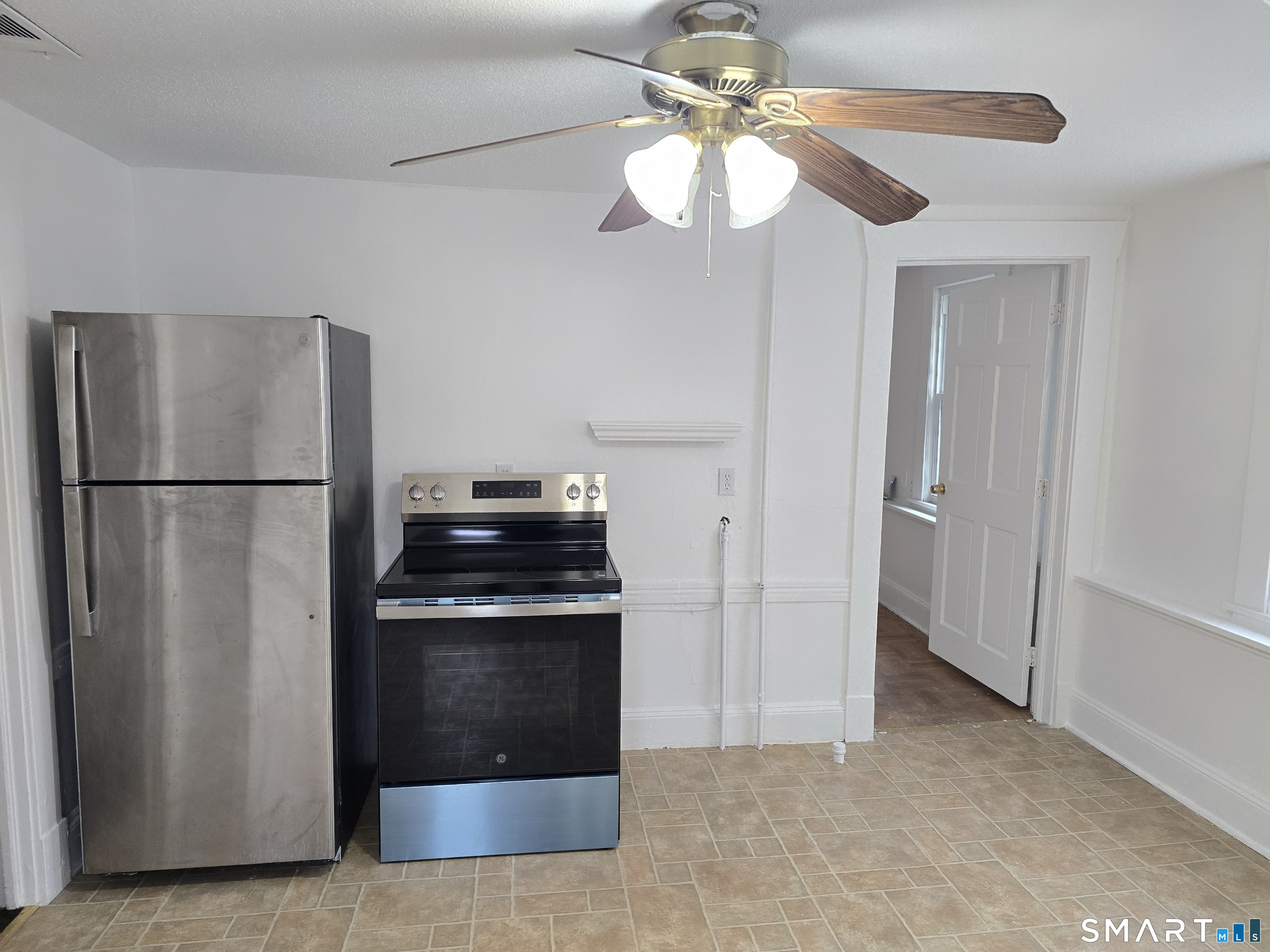 103 Capen Street, Unit 2 Windsor, CT 06095 - Photo 3 of 10 a kitchen with stainless steel appliances granite countertop a refrigerator a stove and a granite counter tops