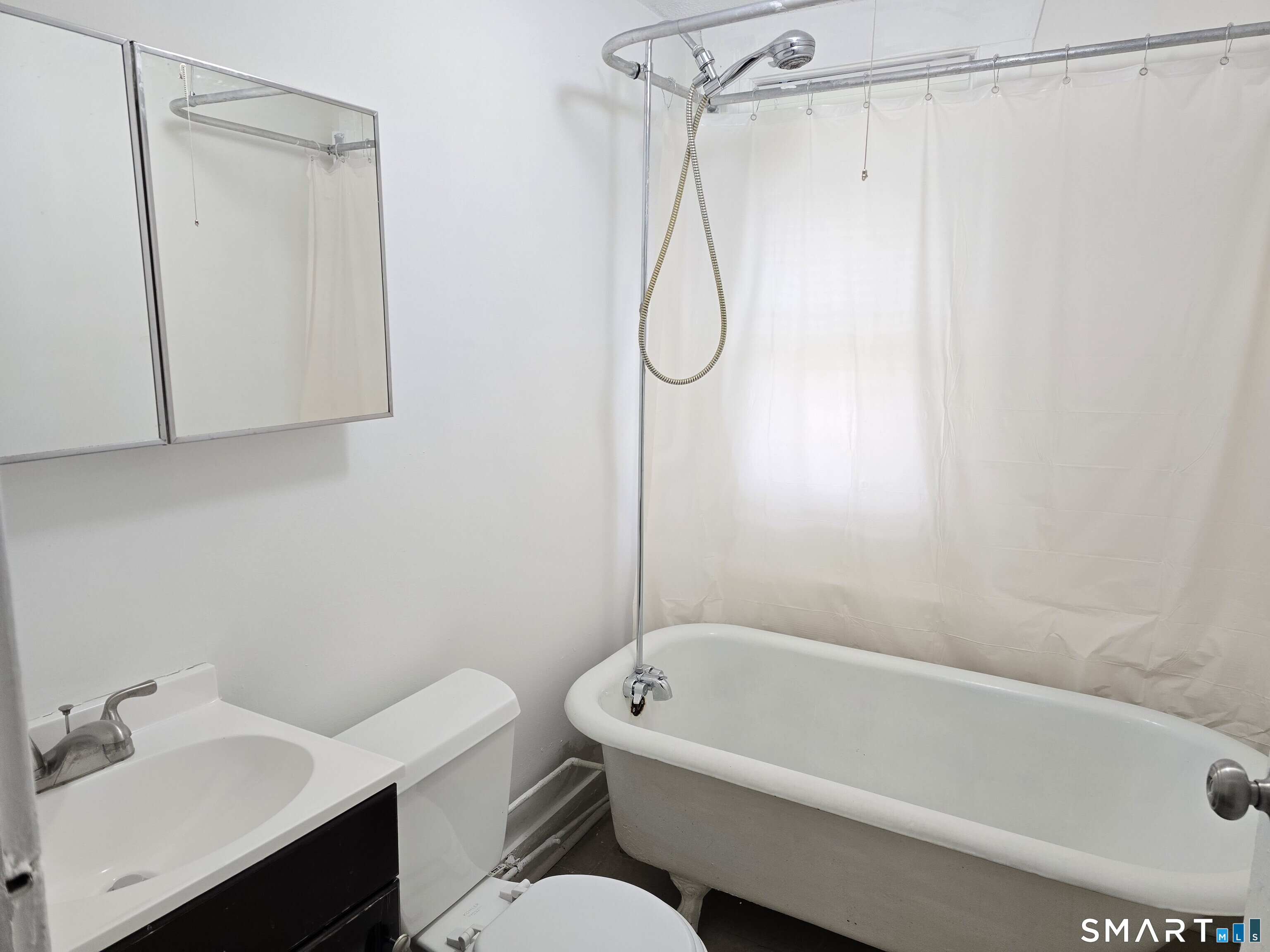 103 Capen Street, Unit 2 Windsor, CT 06095 - Photo 5 of 10 a bathroom with a bath tub a sink and a toilet