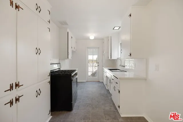 a kitchen with a refrigerator and a stove