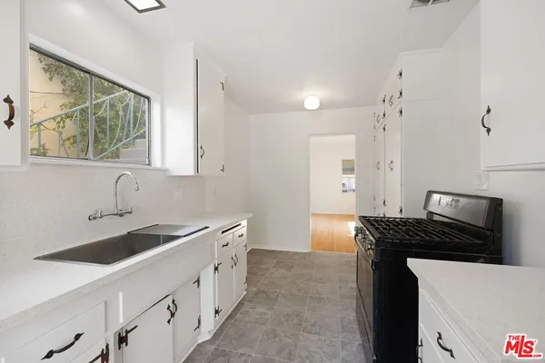 a kitchen that has a sink and a stove