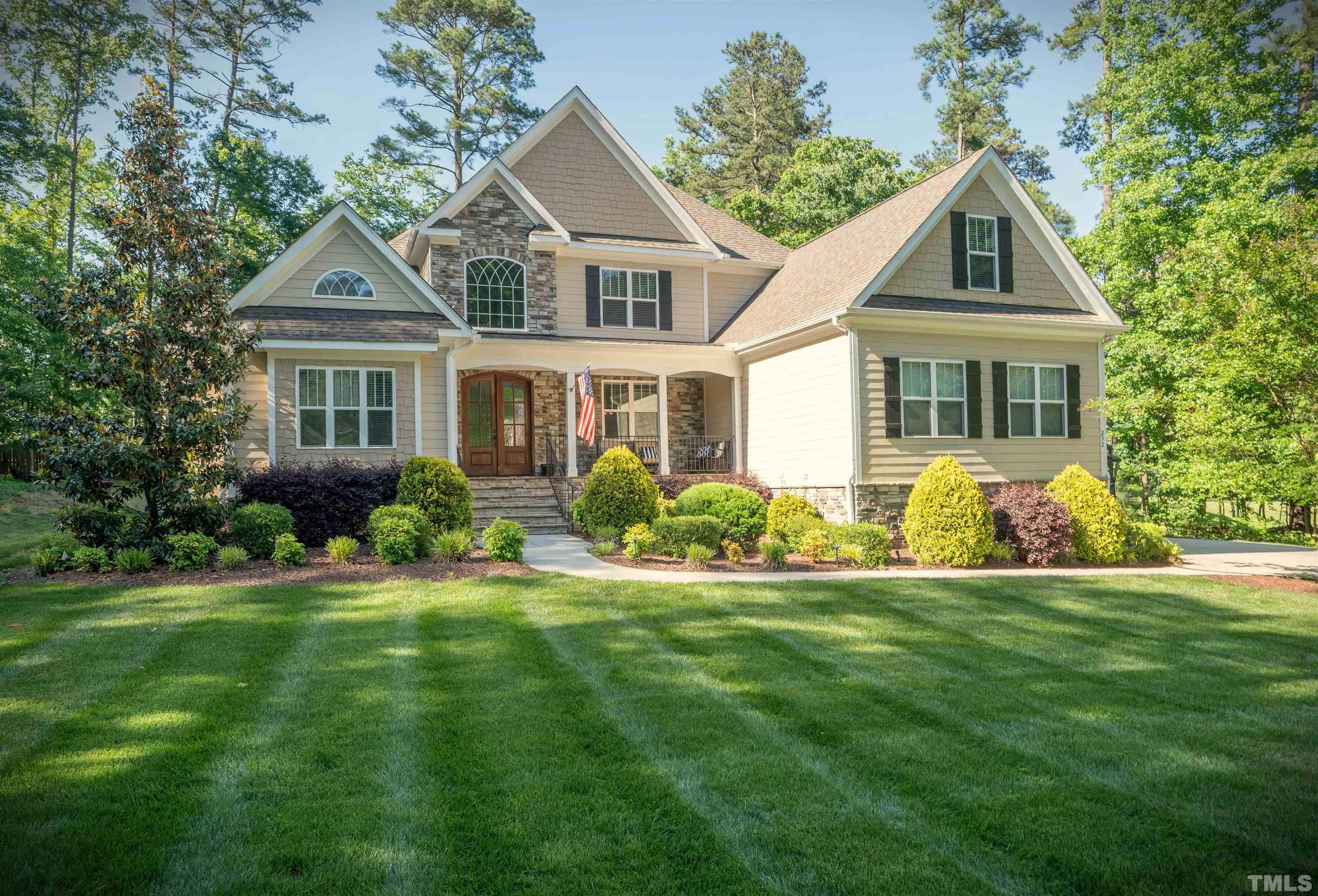 232 Bayleaf Drive Raleigh, NC 27615 - Photo 1 of 26 a front view of a house with a yard and trees