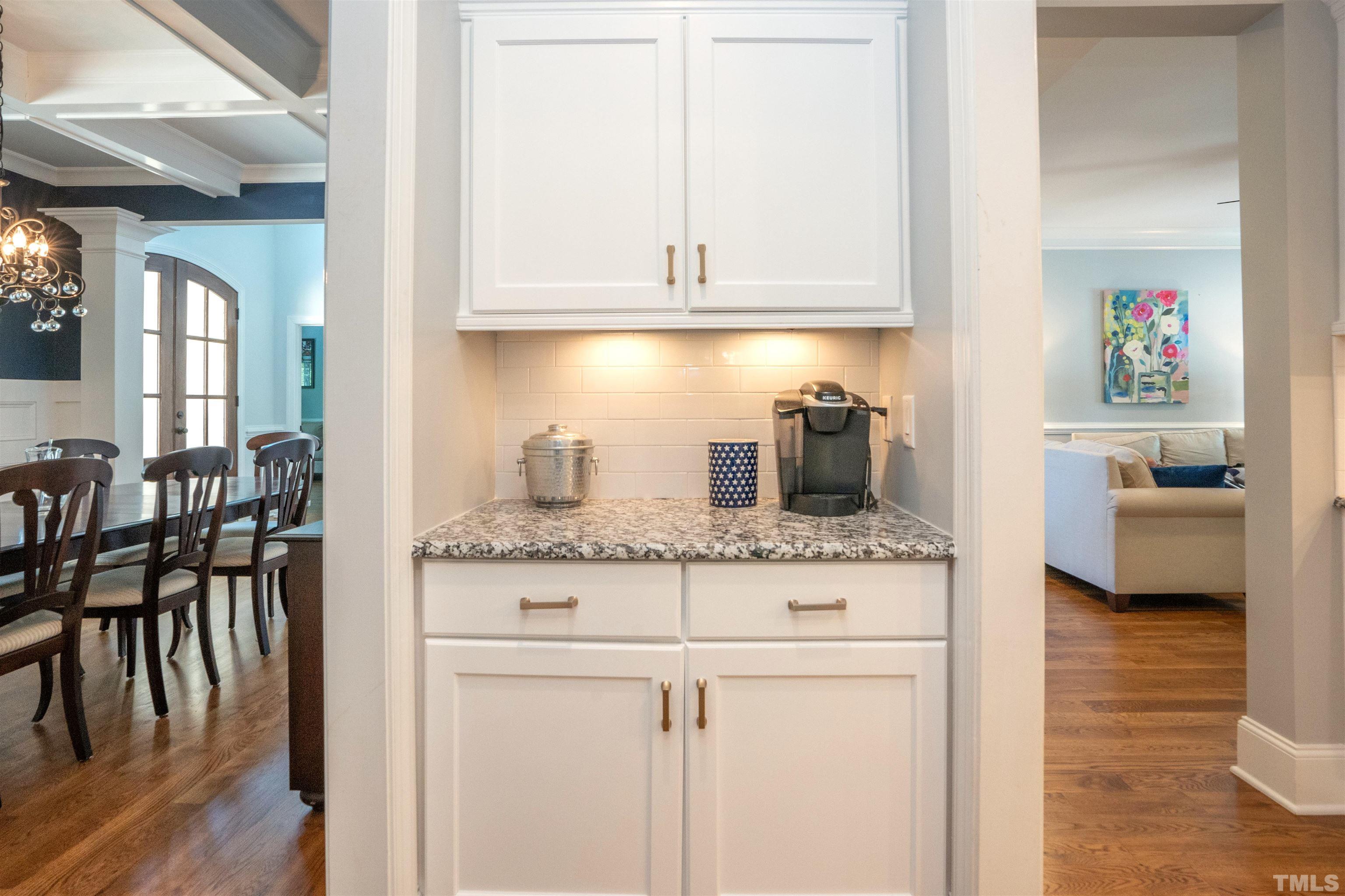 232 Bayleaf Drive Raleigh, NC 27615 - Photo 11 of 26 a kitchen with granite countertop white cabinets and wooden floor