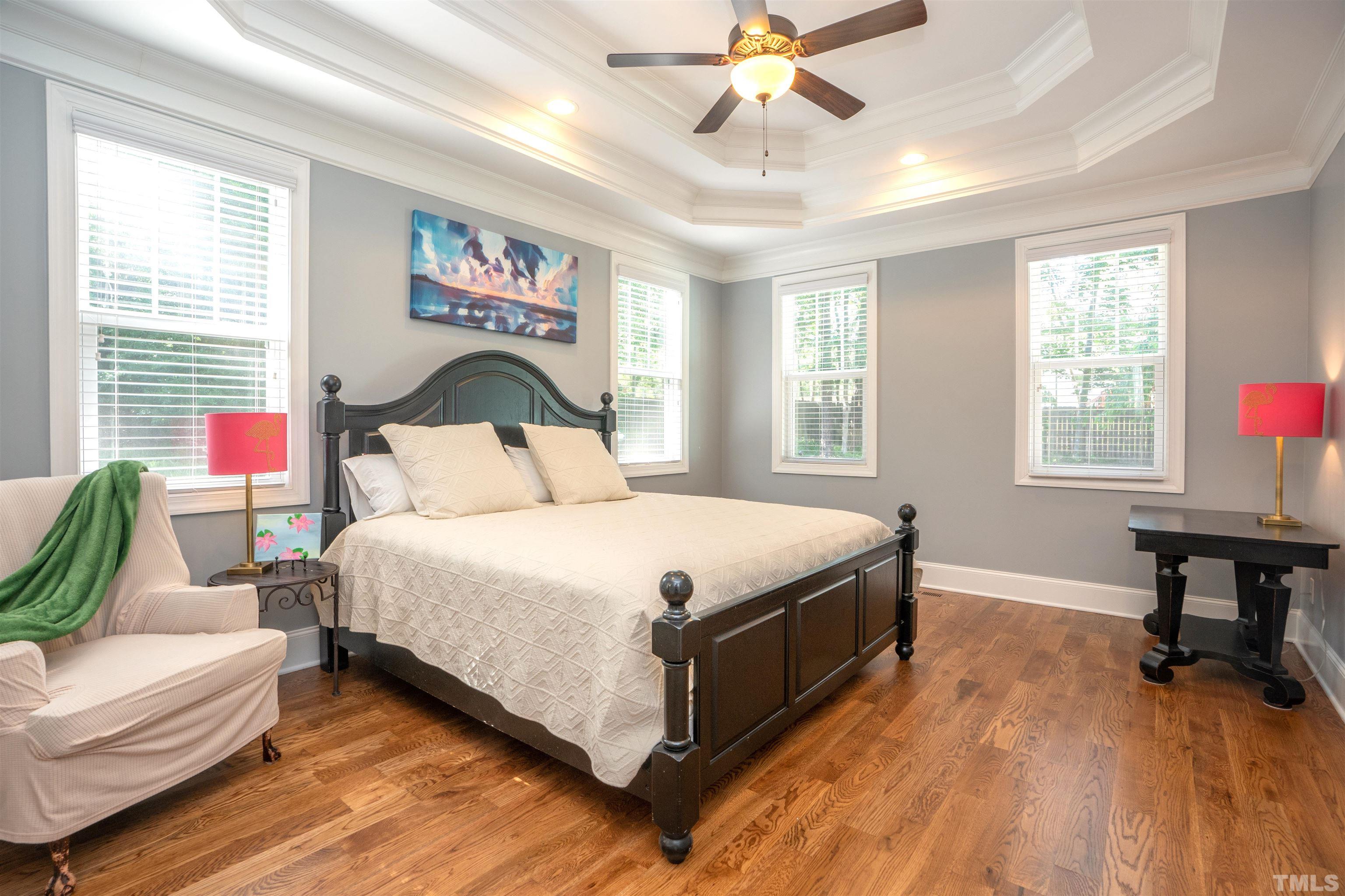 232 Bayleaf Drive Raleigh, NC 27615 - Photo 12 of 26 a bedroom with a bed and a chandelier