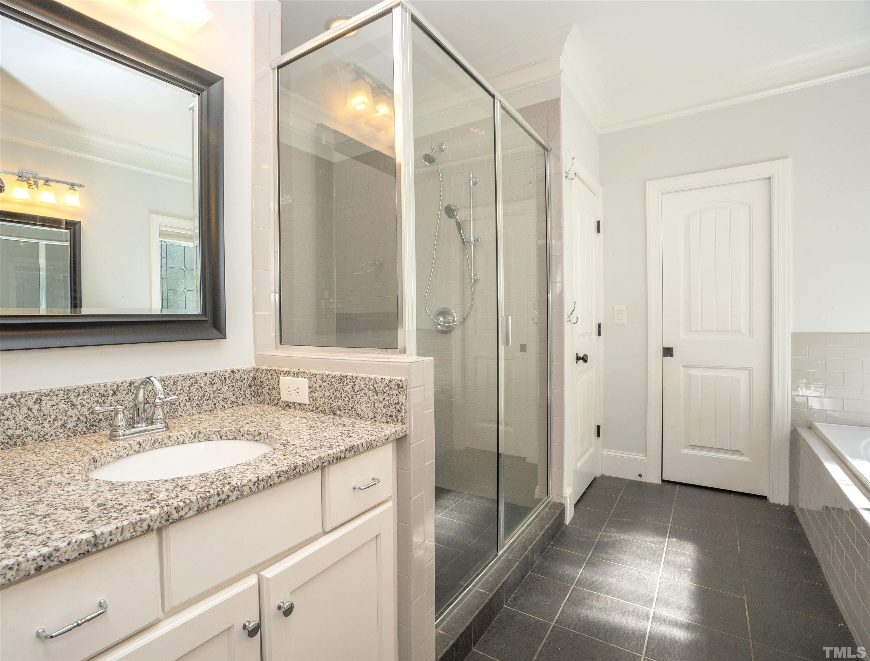 232 Bayleaf Drive Raleigh, NC 27615 - Photo 13 of 26 a bathroom with a granite countertop sink two mirror and a shower