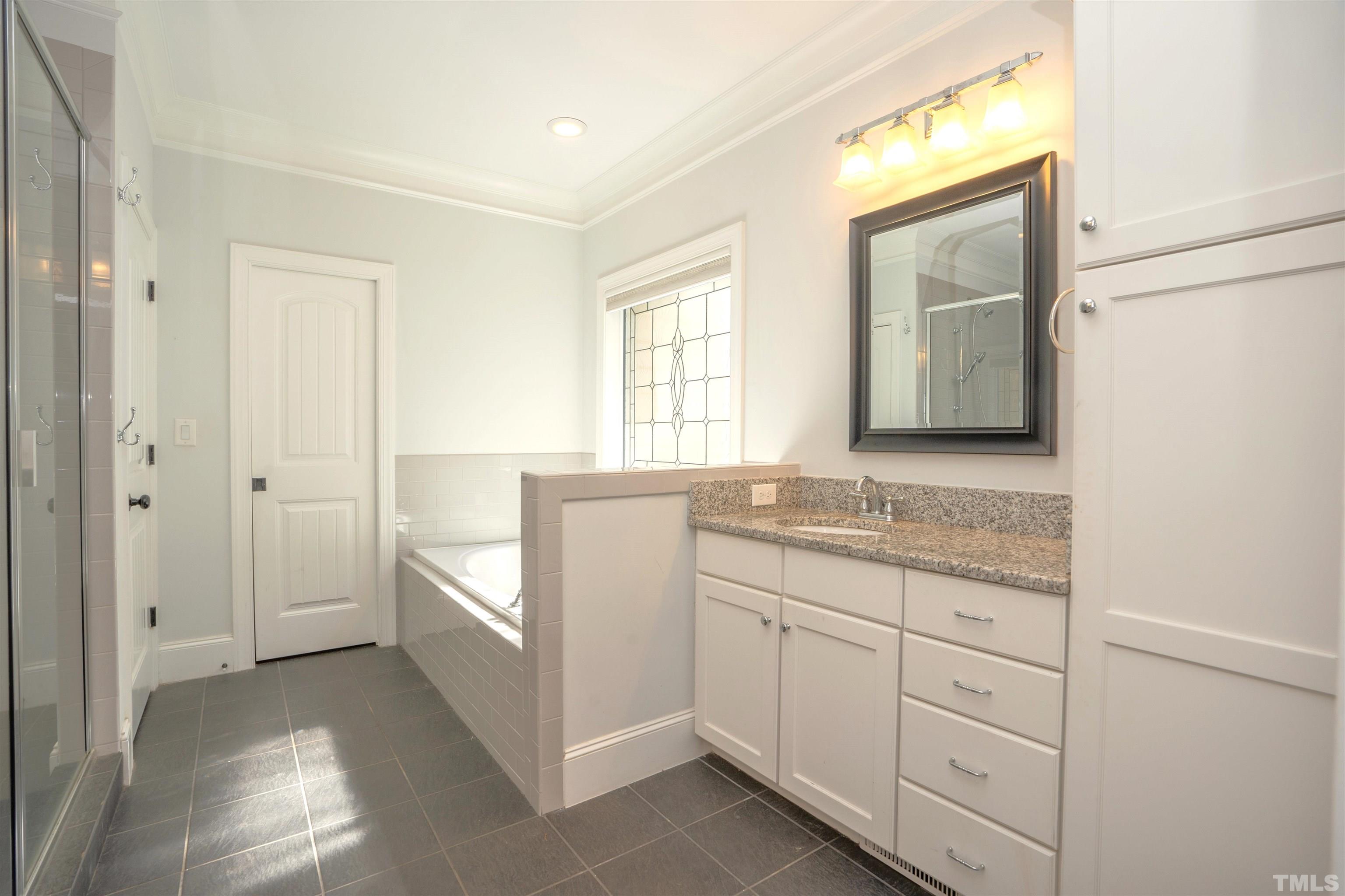 232 Bayleaf Drive Raleigh, NC 27615 - Photo 14 of 26 a bathroom with a granite countertop sink and a mirror