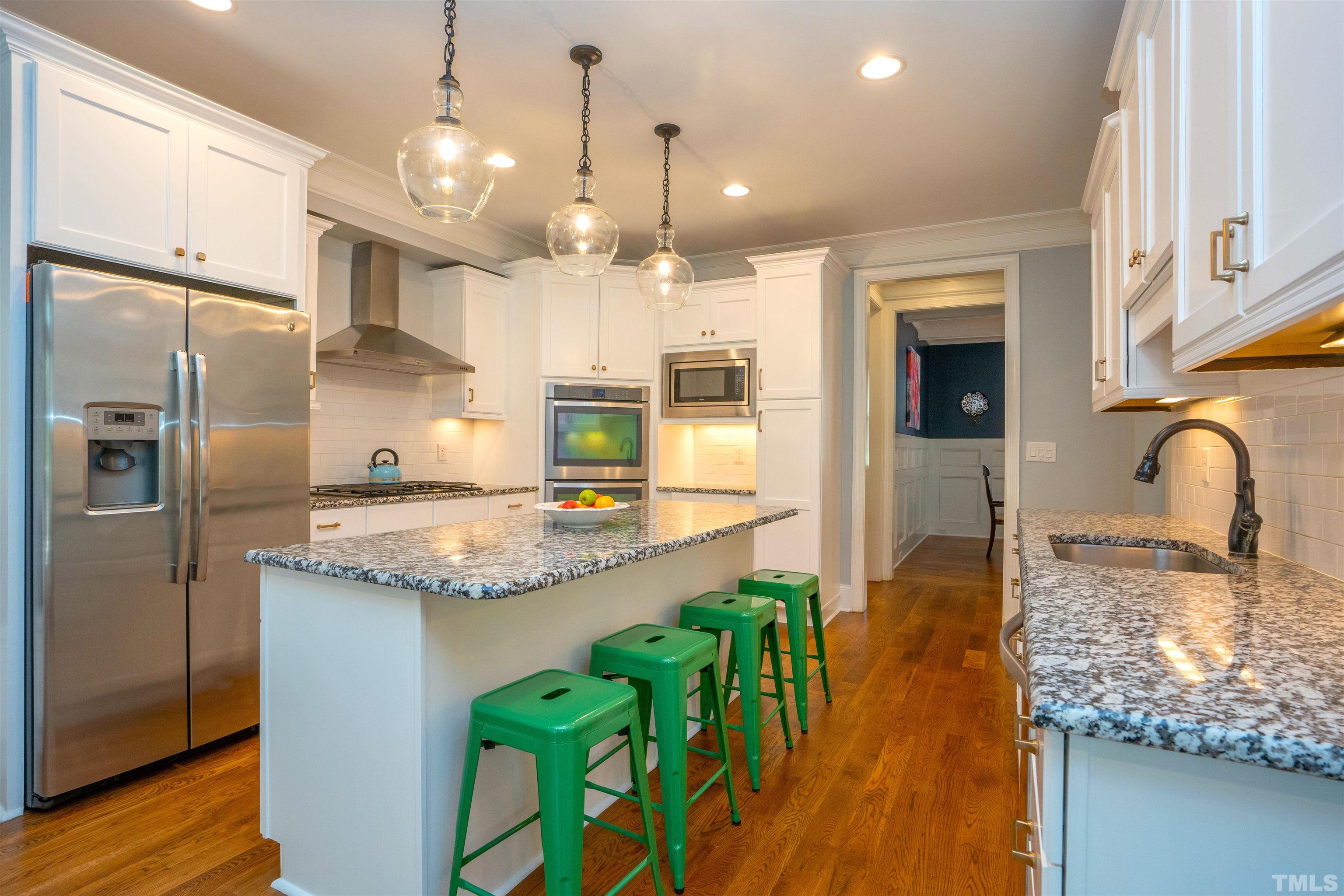 232 Bayleaf Drive Raleigh, NC 27615 - Photo 8 of 26 a kitchen with stainless steel appliances granite countertop a sink a stove and a refrigerator