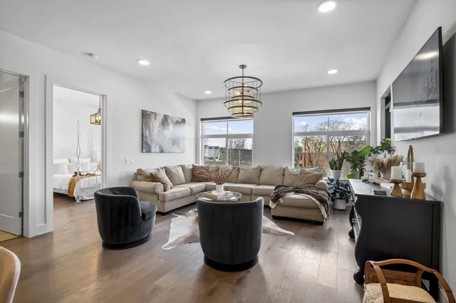 a living room with furniture potted plant and a window
