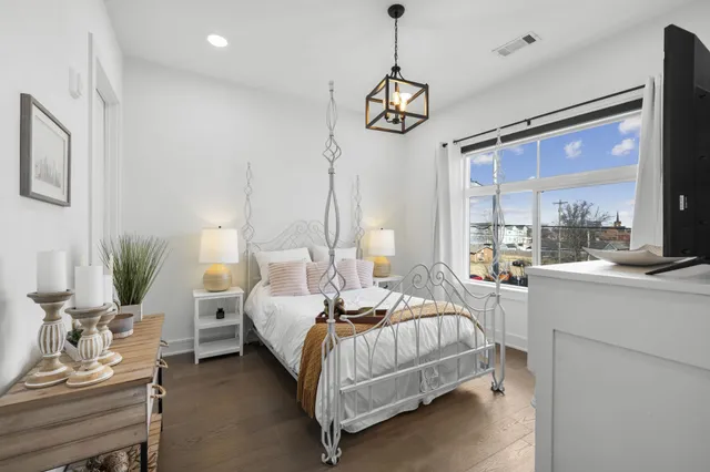 a bedroom with bed and a large window