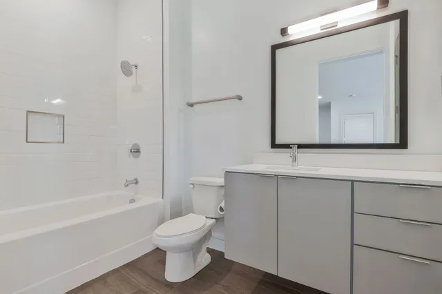 a bathroom with a toilet sink and mirror