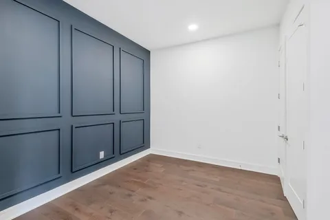 an empty room with wooden floor