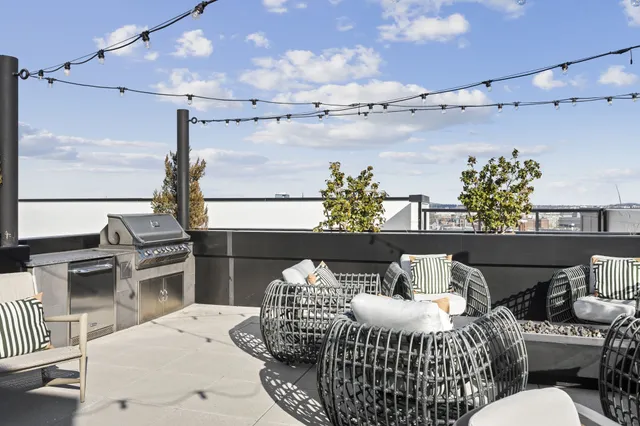 a balcony with furniture and a kitchen view