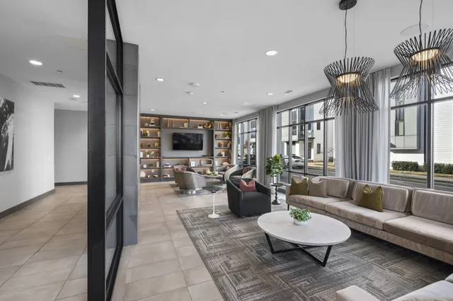 a living room with furniture a rug and a chandelier