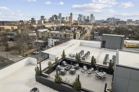 a terrace with a couch and chairs