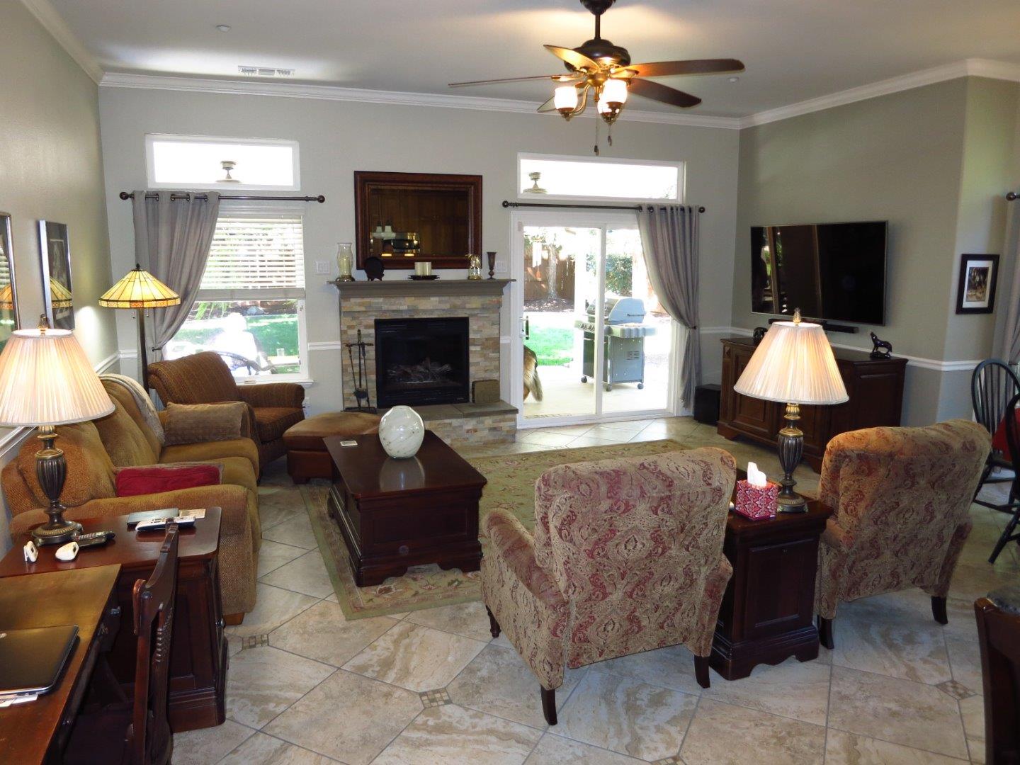 1847 Tartan Road Turlock, CA 95382 - Photo 23 of 37 a living room with furniture a fireplace and a flat screen tv