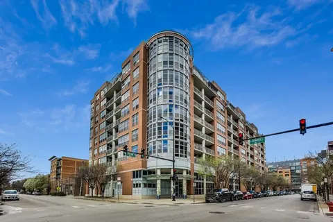 a view of a tall building next to a road