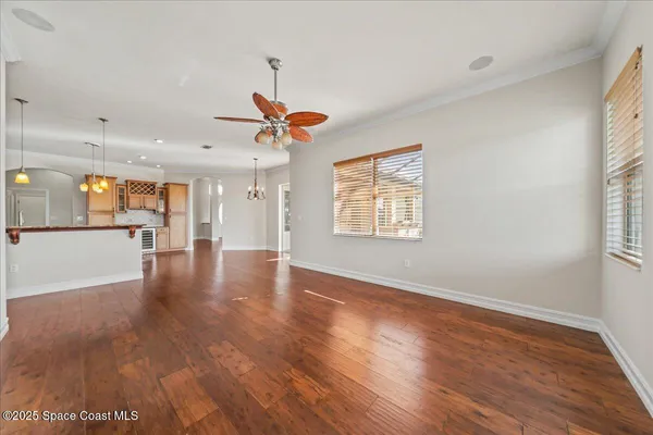 a spacious bedroom with a large bed and a chandelier