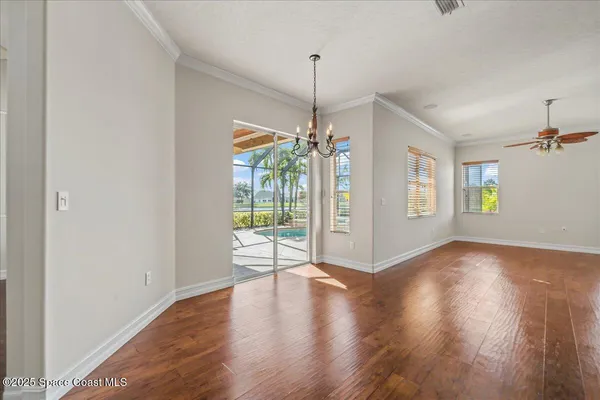 a view of empty room with wooden floor