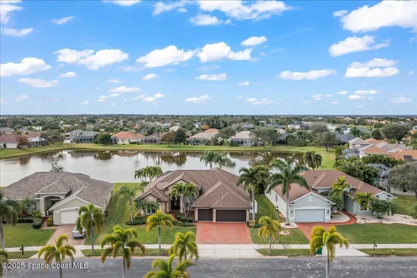 an aerial view of a house with a yard