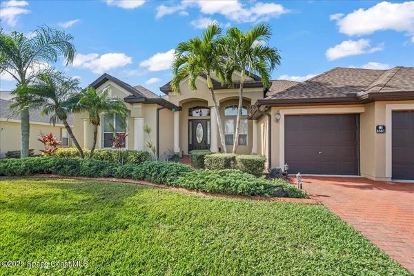 a view of a dining room with furniture wooden floor and a chandelier