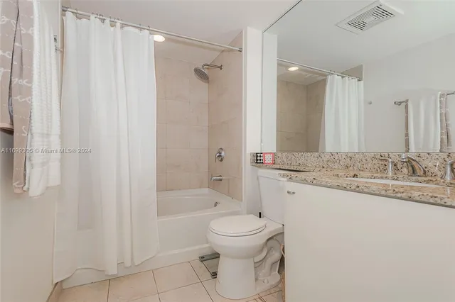 a bathroom with a shower and a sink